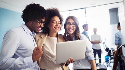 Students looking at laptop together Students looking at laptop together